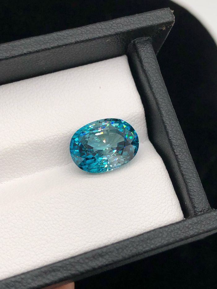 Blue gemstone displayed in a luxurious jewelry box, showcasing elegance and luxury.
