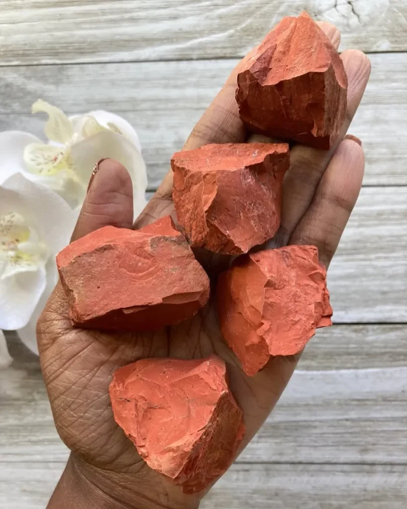 Natural raw rough red jasper crystal chunks displaying earthy terracotta and brick-red tones for lapidary and healing.