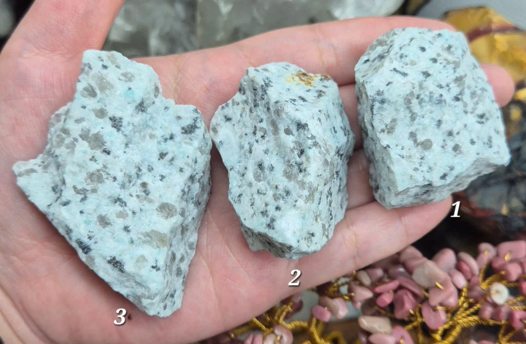 Natural raw unpolished kiwi jasper stones displaying mint green feldspar, embedded quartz pods, and black tourmaline flecks for rock tumbling and crystal healing.