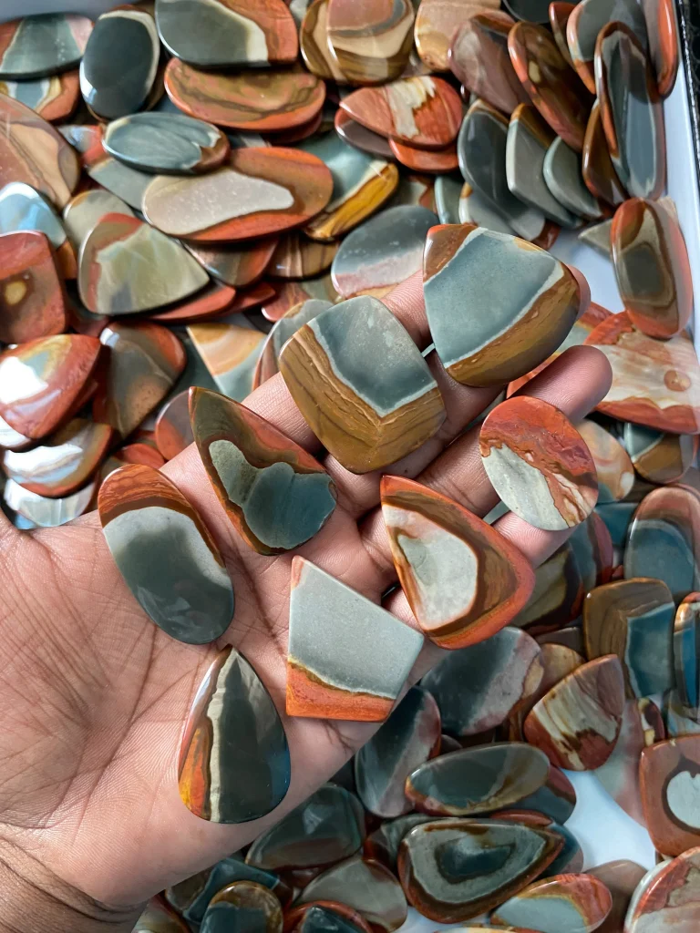 Natural polished polychrome jasper flat-back cabochons (Madagascar Desert Jasper) showing scenic terracotta, mustard, and slate blue banded patterns for artisan jewelry making.