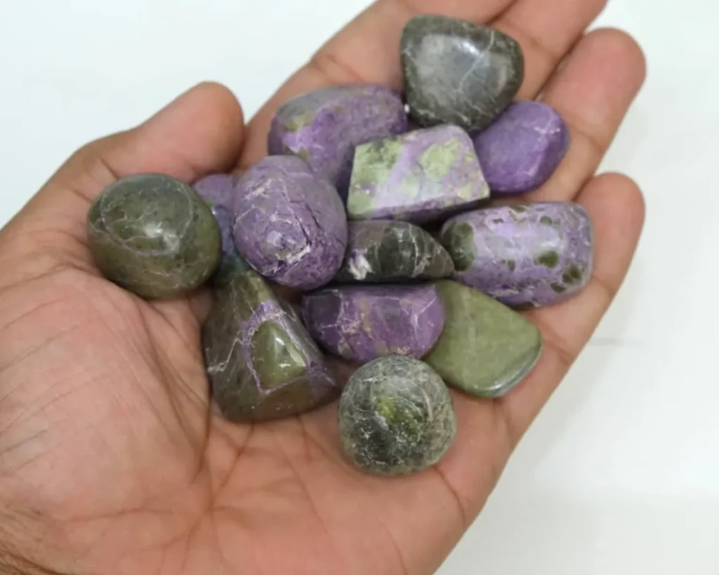 Natural tumbled purple stichtite stones with green serpentine inclusions (Atlantasite) for crystal healing and jewelry making.