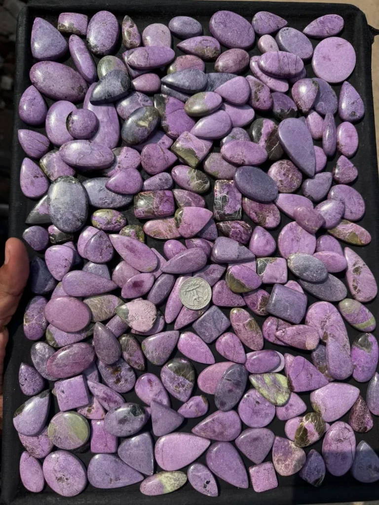 Wholesale parcel of natural polished purple stichtite flat-back cabochons with serpentine accents for artisan jewelry making.