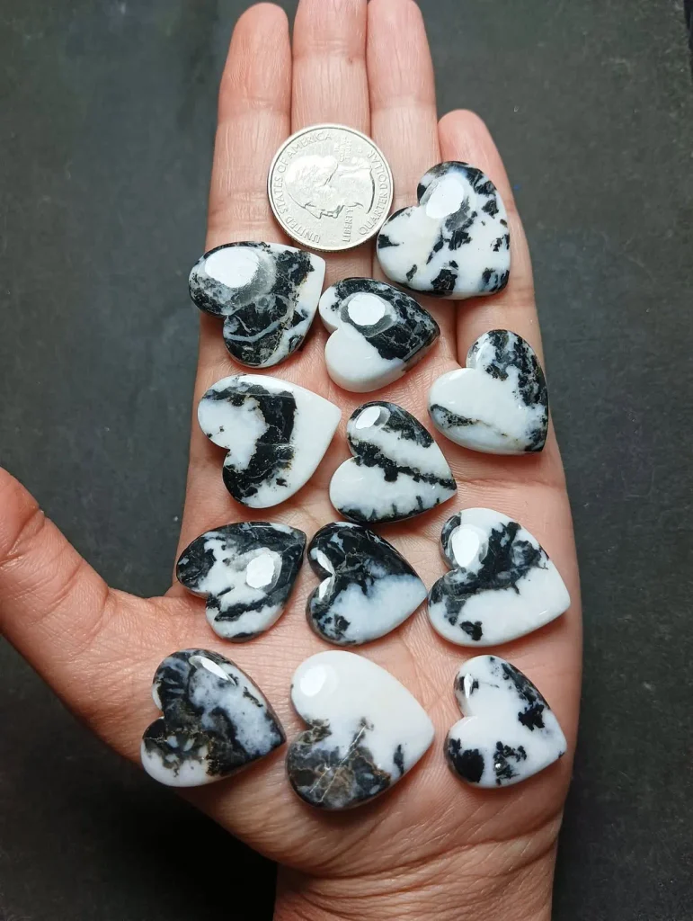 Natural polished heart-shaped zebra jasper flat-back cabochons displaying black and white monochrome patterns for jewelry making.
